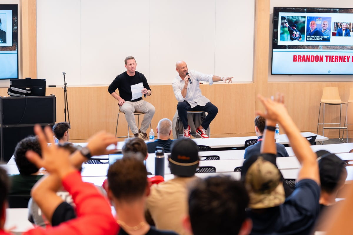 Two speakers engaging with classroom audience.