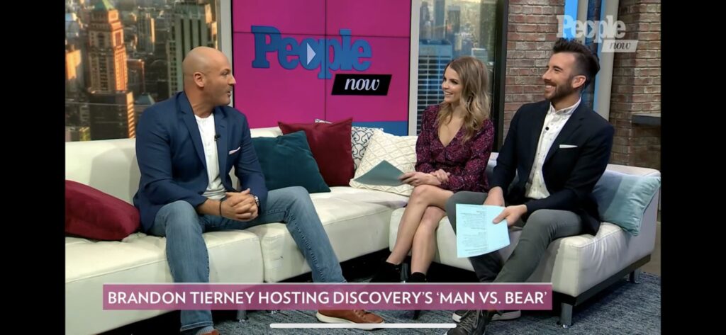 Two hosts engaged in a lively interview on People Now set.