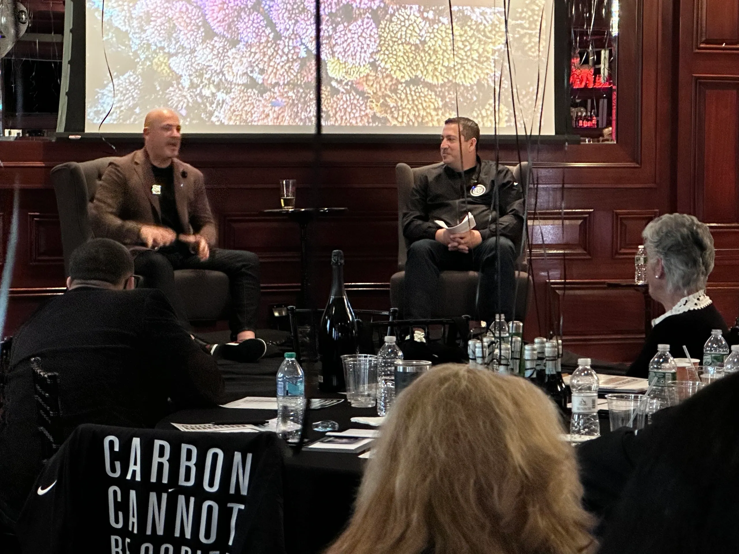 Two men speaking at a conference event.
